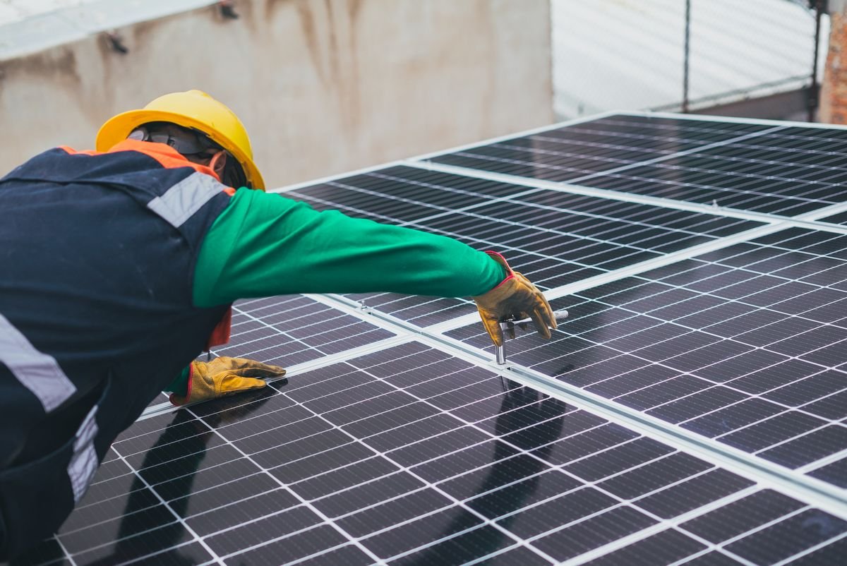 Certified solar engineer inspecting rooftop array